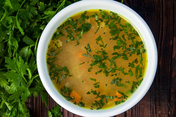 top view soup with vegetables and parsley in a white plate 1 - Суп из черемши
