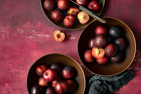 red plums in a bowl summer food flatlay - Ягодный компот на каждый день