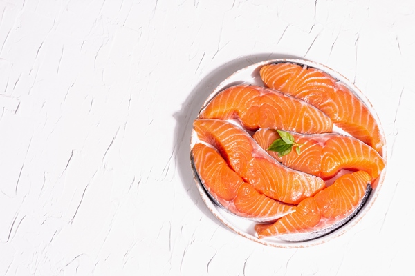 fresh raw salmon or trout fish fillet steaks minimalistic design modern hard light dark shadow chilled ingredients for cooking healthy seafood white putty culinary background top view - Рыбные шашлыки с постным яблочным соусом