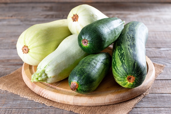 fresh zucchini on board on wooden table healthy vegetarian ingredient - Острая закуска из кабачков "Тёщин язык"