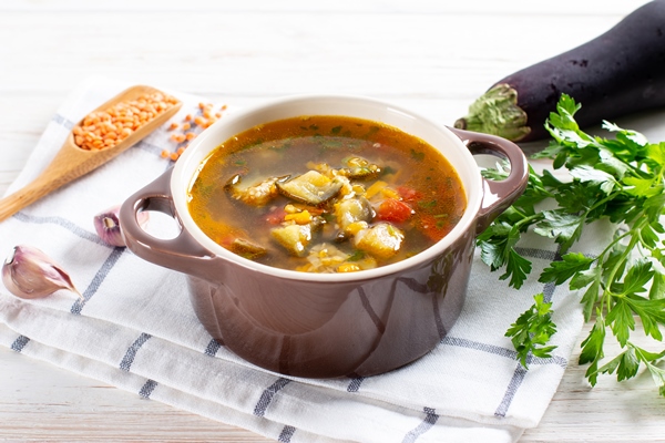 soup with lentils and vegetables on a light table - Овощной суп с баклажанами и чечевицей