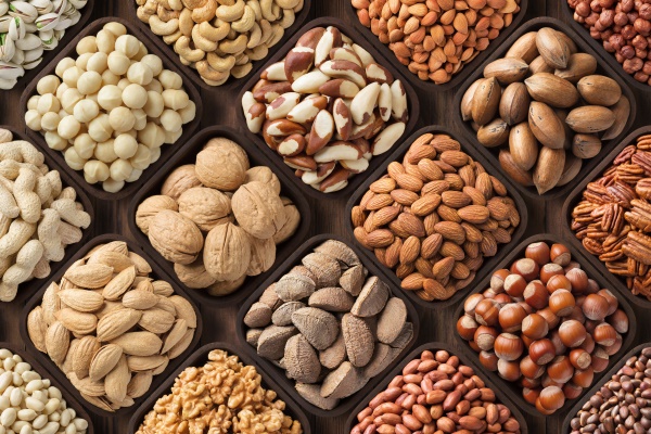 assorted nuts background large mix seeds raw food products pecan hazelnuts walnuts pistachios almonds macadamia cashew peanut and other - Растительное молоко: виды и свойства