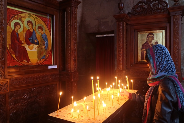 woman offering a candle in historic church of jvari monastery mtskheta town georgia - Растительное молоко: виды и свойства