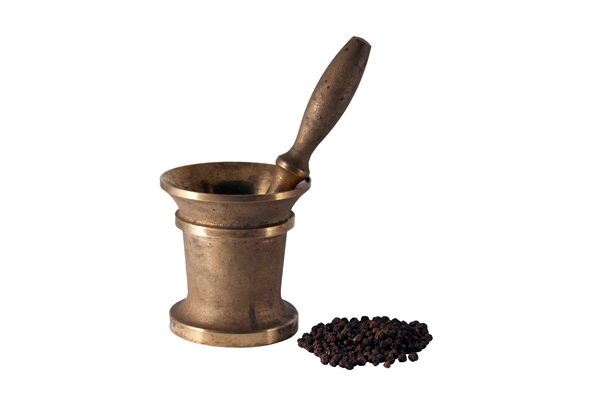 ancient bronze mortar and a handful of black pepper peas on a white background - Капустный взвар