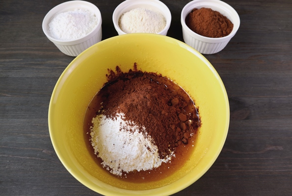 flour and cocoa powder in a mixing bowl with bowls of ingredients - Торт "Рождественское полено" с вишней