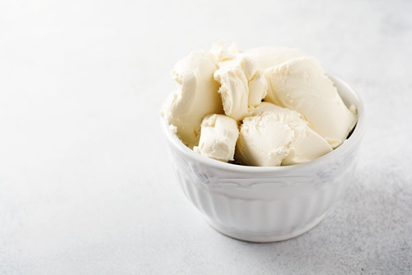 fresh mascarpone cheese in a white bowl for making italian tiramisu dessert on light - Торт "Рождественское полено" с вишней