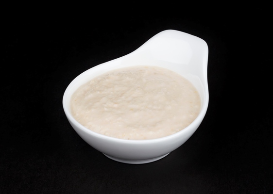 horseradish sauce in white bowl isolated on black background - Русский столовый хрен