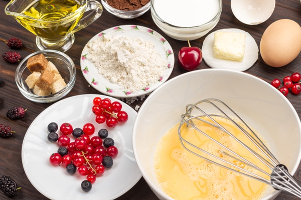 ingredients for baking berry pie metal whisk in bowl with broken egg 1 - Торт "Рождественское полено" с вишней
