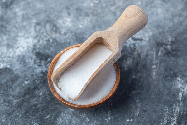 salt in a wooden spoon on a marble background - Заправка в квашеную капусту