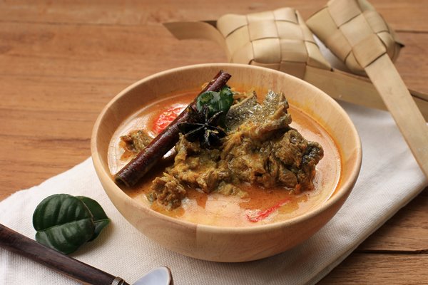 gulai sapi is beef curry typically traditional food from padang west sumatera indonesia served at the table with bowl and ketupat lebaran menu for eid al adha idul adha - Баранина по-индийски