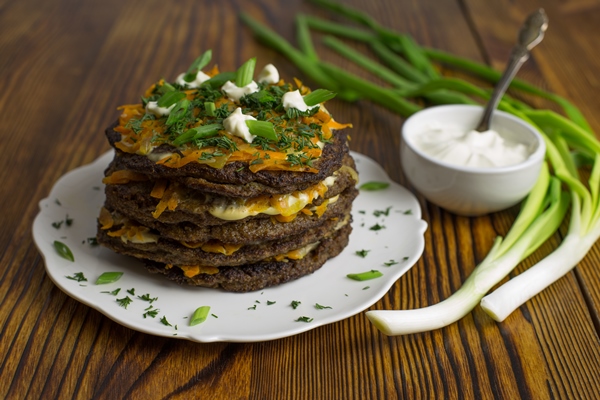 liver pie with carrots onions and cream sauce on a wooden table - Печёночный пирог с морковью и луком