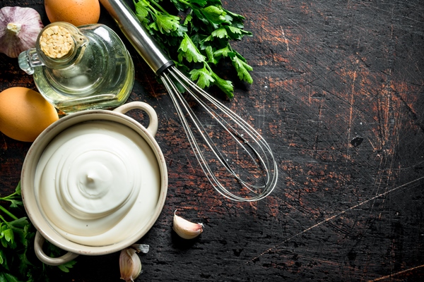 mayonnaise with herbs oil and garlic on dark rustic table - Печёночный пирог с морковью и луком