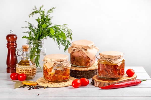 glass jars with homemade canned meat from farm poultry goose duck chicken with copy space - Утиное конфи