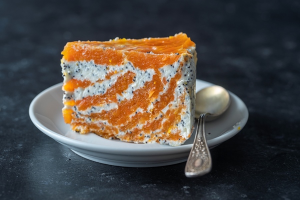piece of delicate carrot curd cake with poppy honey and orange juice in plate close up cake without baking - Маковая пасха с апельсиновым конфитюром
