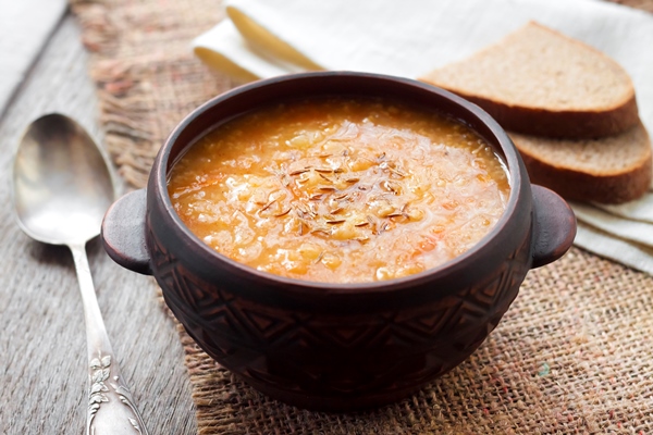 kapustnyak traditional ukrainian winter soup with sauerkraut millet and meat in rustic bowl - Щи солдатские