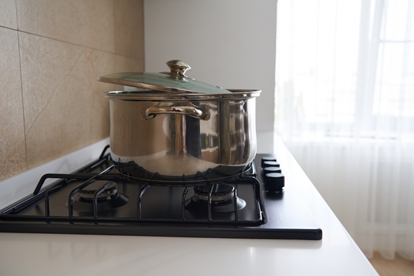 pan on the gas stove in kitchen interior stainless steel pot cooking utensils concept - Мука (крупа) из жёлудей