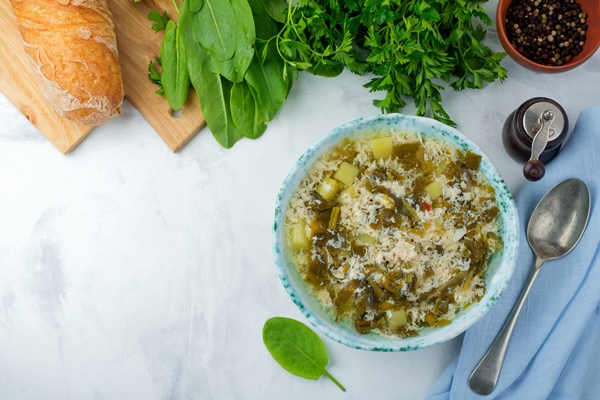 simple vegetarian soup made of sorrel potatoes and beaten eggs on a light background selective focus top view - Молодые побеги кипрея (иван-чая)