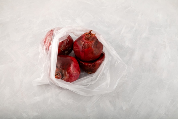 spoiled pomegranate fruits in plastic bag ugly rotten moldy fruits improper food storage - Как перестать выбрасывать продукты и сократить расходы