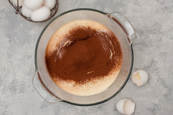 beaten eggs with sugar flour and cocoa in a bowl for making chocolate sponge cake - Торт "Зебра"