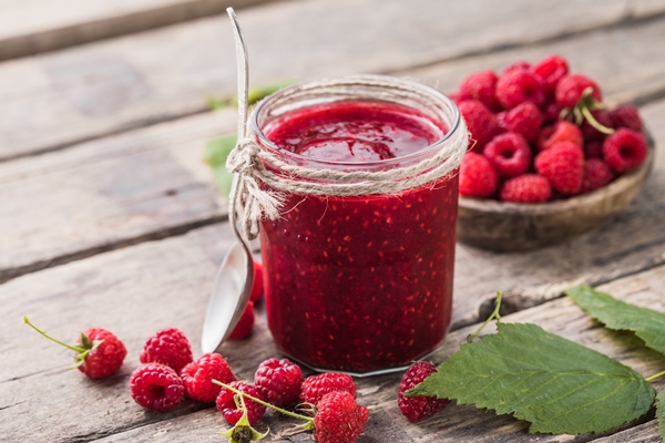 homemade raspberry jam on a wooden background with fresh raspberries selective focus - Малина, протёртая с сахаром