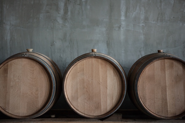 wine barrels stacked in the cellar of the winery - Сбор, заготовка и переработка дикорастущих плодов, ягод и грибов