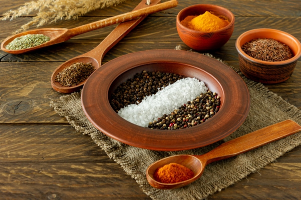 assorted spices in a plate spoons and bowls on wooden background - Пицца из кабачков с грибами