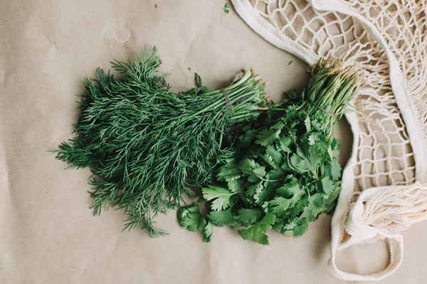 bunches of fresh greens in ecobag organic healthy food surface - Замороженные овощи для супа и вторых блюд