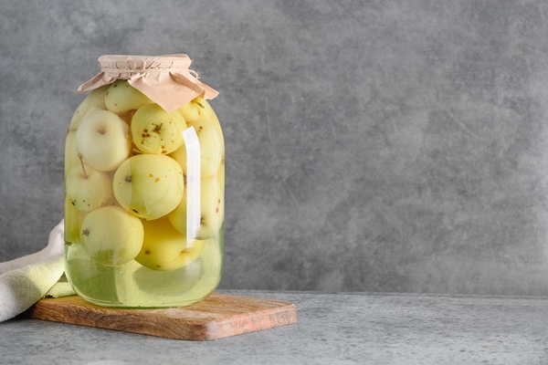 canned apple compote in large glass jars on gray table - Мочёные яблоки в холодном рассоле