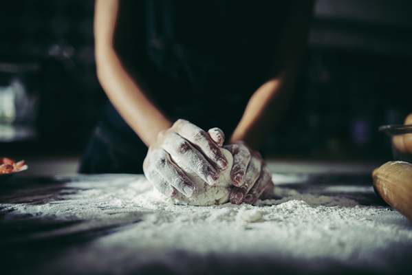 woman kneads dough for make pizza on wooden cooking concept - Пицца "Маргарита"