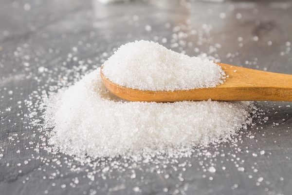 a pile of white sugar sand with a wooden spoon on a dark background - Пицца "Сицилийская"