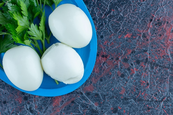 hard boiled egg with herbs on marble background - Секреты приготовления яиц всмятку, "в мешочек" и вкрутую. Пошаговая инструкция