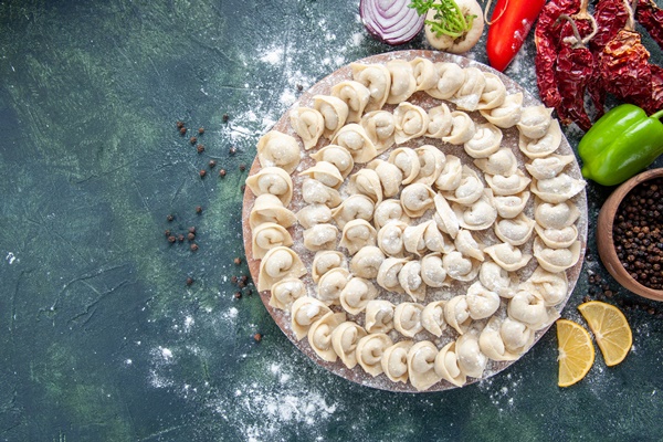 top view little raw dumplings with flour and vegetables on a dark background meat dough food dish calorie color vegetable meal - Кулинарные секреты для одиноких