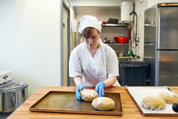 belarus minsk 01 20 2020 a female cook prepares a dough for bread a bakery - Минский хлеб