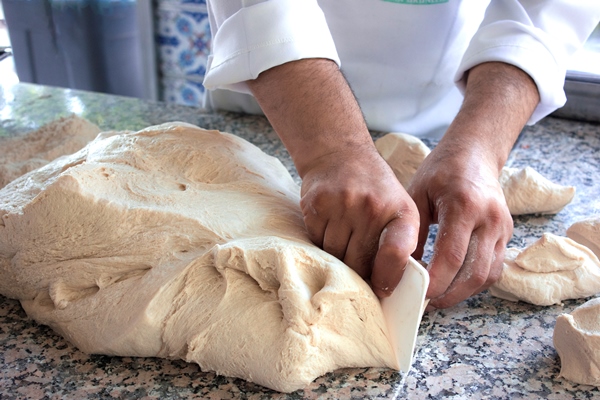 chef cook works with a yeast dough - Рогалики по ГОСТу