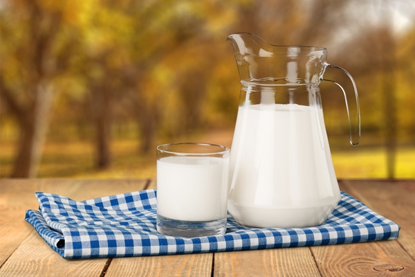 glass of milk and jug on blurred background - Морской хлеб