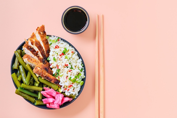 traditional asian street food crispy chicken with soy sauce with a serving of rice green beans spices and herbs homemade chopstick dish ready to eat bright pink background layout with copy space - Пирамида питания
