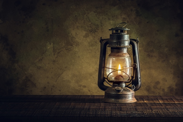 kerosene lamp oil lantern burning with glow soft light on aged wood floor - Оливковое масло