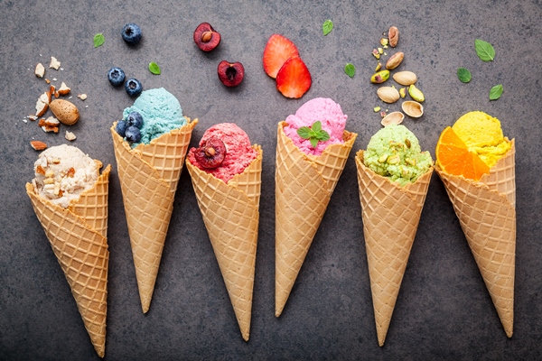 various of ice cream flavor in cones setup on dark stone background - Углеводная питательность рациона