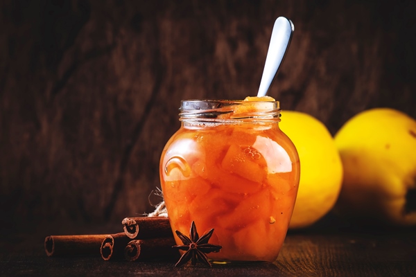winter quince jam or confiture in glass jar with cinnamon and anise on rustic wooden kitchen table background copy space - Углеводная питательность рациона