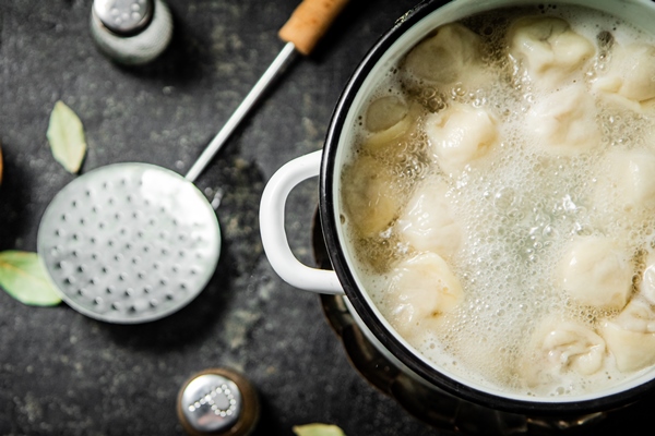 dumplings in a pot of boiling water - Пельмени