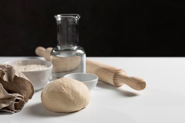 high angle of dough with rolling pin and ingredients - Пельмени