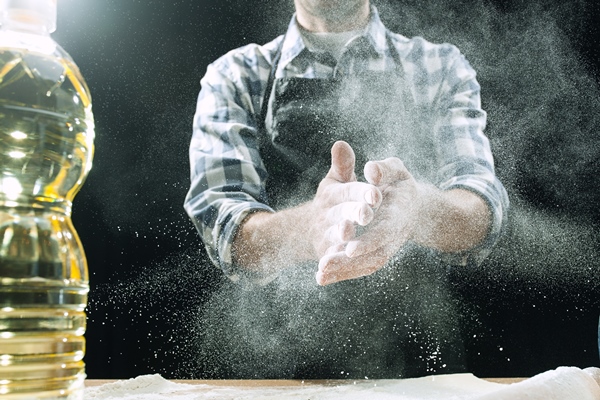 professional male cook sprinkles dough with flour - Постная абрикосовая галета