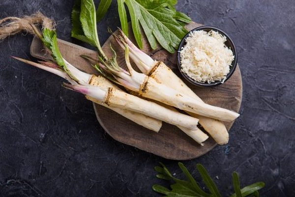 fresh orgaanic horseradish or horse radish root on wooden cutting board rotated e1692282081756 - Вятская окрошка
