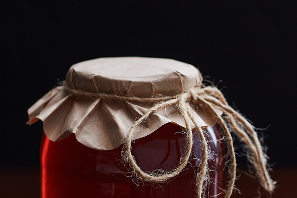 stewed gooseberries and currants in a glass jar dark wooden table - Как правильно варить и хранить варенье