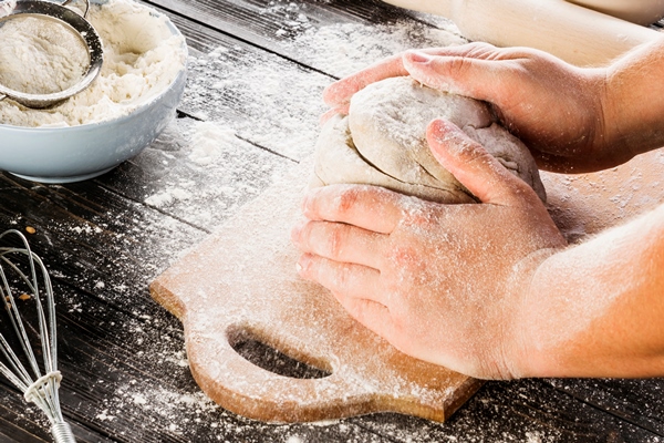 man s hand kneading flour with wheat flour - Монастырская кухня: гречневая лемешка, печенье со смородиной
