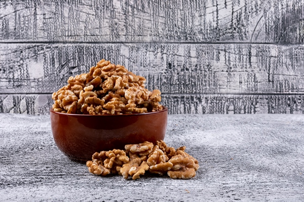 side view walnuts in bowl on stone horizontal - Рулет из лаваша с баклажанами, чесноком и сливочным сыром