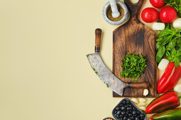 top view of mezzaluna and ffresh vegetables world vegan food day concept - Хозяйке на заметку: виды кухонных ножей