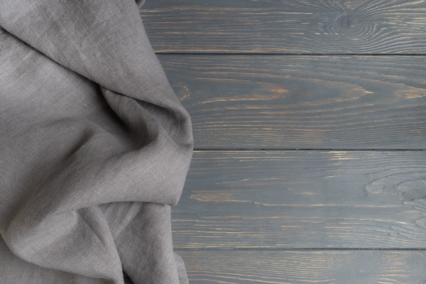 gray linen towel on a gray wooden background with space for text layout template - Православная поминальная трапеза