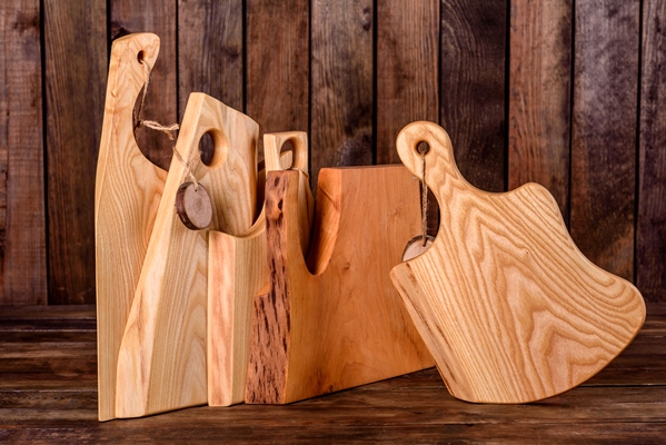set of beautiful wooden cutting boards on a wooden table cooking in the kitchen - Организация правильного питания детей