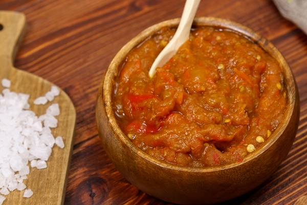 ajvar delicious dish of red peppers and eggplant waiting for tasting wooden background - Овощная икра (школьное питание)
